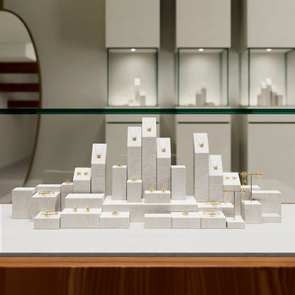 White Linen Jewelry Display Set with Multi-Level Risers for Vendors